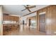 Open-concept living area with hardwood floors and a small desk area located off the kitchen at 35934 Verano Ln, Zephyrhills, FL 33541