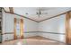 Bright living room featuring wood-look floors, ceiling fan, and wood trim detail at 35934 Verano Ln, Zephyrhills, FL 33541