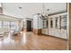 Open-concept living area with hardwood floors, a decorative chandelier, and ample natural light at 35934 Verano Ln, Zephyrhills, FL 33541