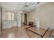 Bedroom with built-in dresser, mirror closet, ceiling fan, and wood look floors at 35934 Verano Ln, Zephyrhills, FL 33541