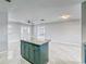 Kitchen island with teal cabinets and granite countertop at 404 13Th Sw St, Ruskin, FL 33570