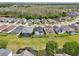 Aerial view showcasing the community homes with fenced yards, pool enclosures and serene setting at 4735 Rolling Green Dr, Wesley Chapel, FL 33543