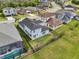 Aerial shot of home with fenced yard, complemented by manicured lawns and neighboring residences at 4735 Rolling Green Dr, Wesley Chapel, FL 33543