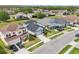A view of the street with manicured lawns, mature landscaping and attached garages at 4735 Rolling Green Dr, Wesley Chapel, FL 33543
