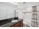 Updated bathroom showcasing vanity with dark granite countertop and a shower-tub combo at 4735 Rolling Green Dr, Wesley Chapel, FL 33543