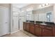 Bathroom with double vanity, granite countertop and a glass enclosed shower stall at 4735 Rolling Green Dr, Wesley Chapel, FL 33543