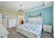 Beautiful bedroom with tray ceilings, coastal decor, and an ensuite bathroom at 4735 Rolling Green Dr, Wesley Chapel, FL 33543