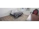 Bright bedroom with gray bed, natural light, and desk, set for comfort and productivity at 4735 Rolling Green Dr, Wesley Chapel, FL 33543