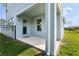 A view of the outdoor covered patio with a concrete slab and access door to the home at 4735 Rolling Green Dr, Wesley Chapel, FL 33543