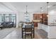 Open-concept dining area seamlessly connects the living room and modern kitchen at 4735 Rolling Green Dr, Wesley Chapel, FL 33543