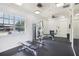 Bright community gym with weightlifting equipment, mirrors, and fans at 4735 Rolling Green Dr, Wesley Chapel, FL 33543