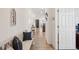Inviting hallway with decorative accents, a bench with throw pillows, and access to other areas of the home at 4735 Rolling Green Dr, Wesley Chapel, FL 33543