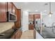 Modern kitchen with stainless steel appliances, cooktop, and granite countertops at 4735 Rolling Green Dr, Wesley Chapel, FL 33543