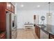 Modern kitchen features stainless steel refrigerator, granite countertops, and ample cabinet space at 4735 Rolling Green Dr, Wesley Chapel, FL 33543