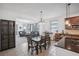 Eat-in kitchen with tile floors and a granite kitchen island with stainless steel appliances at 4735 Rolling Green Dr, Wesley Chapel, FL 33543
