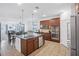 Kitchen has stainless appliances, granite counters and a seamless flow into the living room at 4735 Rolling Green Dr, Wesley Chapel, FL 33543