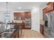 Modern kitchen featuring stainless steel appliances, granite countertops, and a view to the living room at 4735 Rolling Green Dr, Wesley Chapel, FL 33543