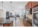 Bright kitchen boasts granite countertops, stainless appliances, and easy access to the living and dining area at 4735 Rolling Green Dr, Wesley Chapel, FL 33543