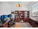 Well-lit office with built-in bookshelves, a spacious desk, and comfortable seating at 4735 Rolling Green Dr, Wesley Chapel, FL 33543