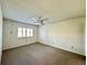 Spacious bedroom with plush carpet, ceiling fan, and bright window at 4910 Bay Ne St # 103, St Petersburg, FL 33703
