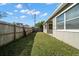 Fenced backyard with grassy lawn and home exterior view at 6132 105Th Ter, Pinellas Park, FL 33782