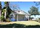 Spacious backyard with covered patio, lush lawn, and mature trees at 8040 Pasadena Dr, Port Richey, FL 34668