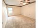 Large bedroom with a window and ceiling fan at 8040 Pasadena Dr, Port Richey, FL 34668