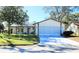 One-story house with attached garage, and landscaped lawn at 8040 Pasadena Dr, Port Richey, FL 34668