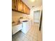 Laundry room with washer, dryer, cabinets, and utility sink at 8040 Pasadena Dr, Port Richey, FL 34668