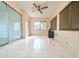 Sunroom with tiled floor, windows, and ceiling fan at 8040 Pasadena Dr, Port Richey, FL 34668