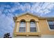 Up close view of the top of a townhome with arched windows at 9042 Moonlit Meadows Loop, Riverview, FL 33578