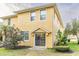 Two-story yellow house with sliding glass doors at 9042 Moonlit Meadows Loop, Riverview, FL 33578