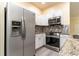 Modern kitchen with stainless steel appliances and granite countertops at 9042 Moonlit Meadows Loop, Riverview, FL 33578