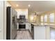 Updated kitchen featuring stainless steel appliances and granite island at 9042 Moonlit Meadows Loop, Riverview, FL 33578
