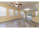Bright living room featuring gray vinyl flooring and lots of natural light at 9042 Moonlit Meadows Loop, Riverview, FL 33578