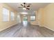 Spacious living room with gray vinyl flooring and access to the backyard at 9042 Moonlit Meadows Loop, Riverview, FL 33578