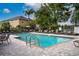 Community pool with lounge chairs and patio area at 9042 Moonlit Meadows Loop, Riverview, FL 33578