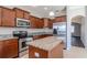 Modern kitchen with granite countertops and island at 13167 Royal Pines Ave, Riverview, FL 33579