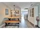 Bright dining room with a rustic wooden table and bench at 17960 Gulf Blvd # 123, Redington Shores, FL 33708