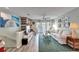 A cozy living room with wood-look floors, a white sofa, and nautical decorations creating a beachy vibe at 17960 Gulf Blvd # 123, Redington Shores, FL 33708