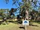 Picnic and grill area with tables under large oak trees at 3001 58Th S Ave # 901, St Petersburg, FL 33712