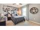 Bright bedroom with a race car wall mural, gray bedding and a window at 32508 Osprey Peak Way, San Antonio, FL 33576