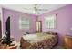 Purple bedroom with camouflage bedding and ceiling fan at 3334 70Th N Way, St Petersburg, FL 33710