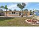 Tan single story house with a landscaped lawn and palm trees at 3334 70Th N Way, St Petersburg, FL 33710