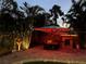 Night view of a relaxing pool area with tiki bar and lighting at 3334 70Th N Way, St Petersburg, FL 33710