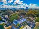 An aerial view of the property surrounded by mature trees and a view of the city skyline at 415 21St N St, St Petersburg, FL 33713
