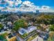 An aerial view of the property surrounded by mature trees and a view of the city skyline at 415 21St N St, St Petersburg, FL 33713