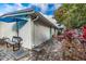 Serene backyard featuring a patio with umbrella, bench, and mature landscaping at 415 21St N St, St Petersburg, FL 33713