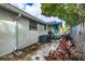 Exterior shot of the backyard showing brick pavers, a turquoise door, and lush landscaping at 415 21St N St, St Petersburg, FL 33713
