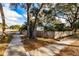 Backyard featuring mature trees and lush landscaping, creating a serene and private outdoor space at 415 21St N St, St Petersburg, FL 33713